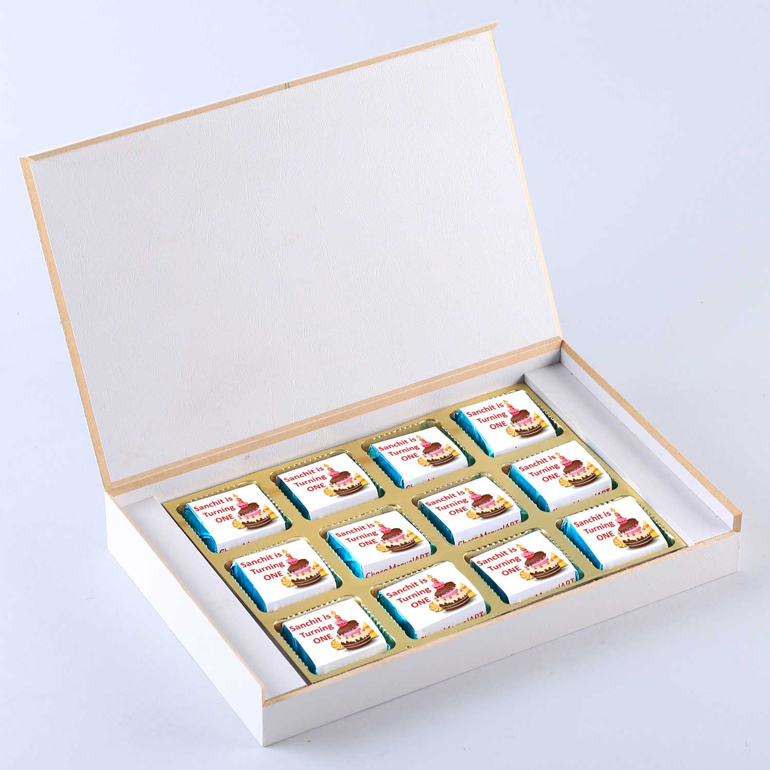customized white wooden box with a wrapper of all-printed chocolates. There is also a personalized message printed on Message paper inside the box.